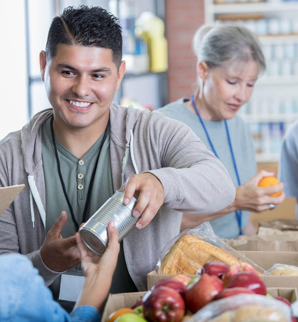 Mid adult Hispanic man volunteers during food drive